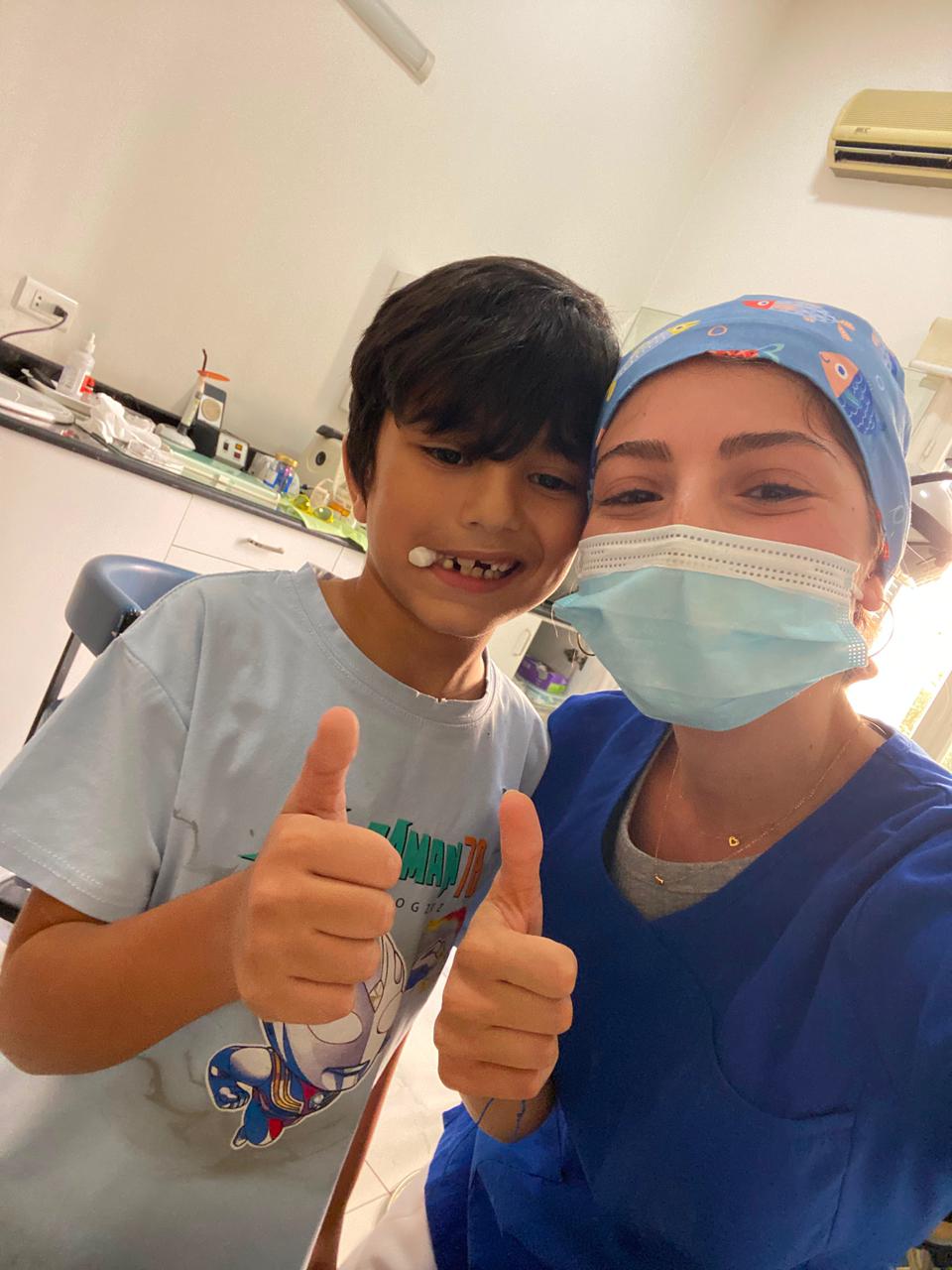 Young boy giving a thumbs-up after his dental check-up with Dr. Marilyn Nohra in Beirut